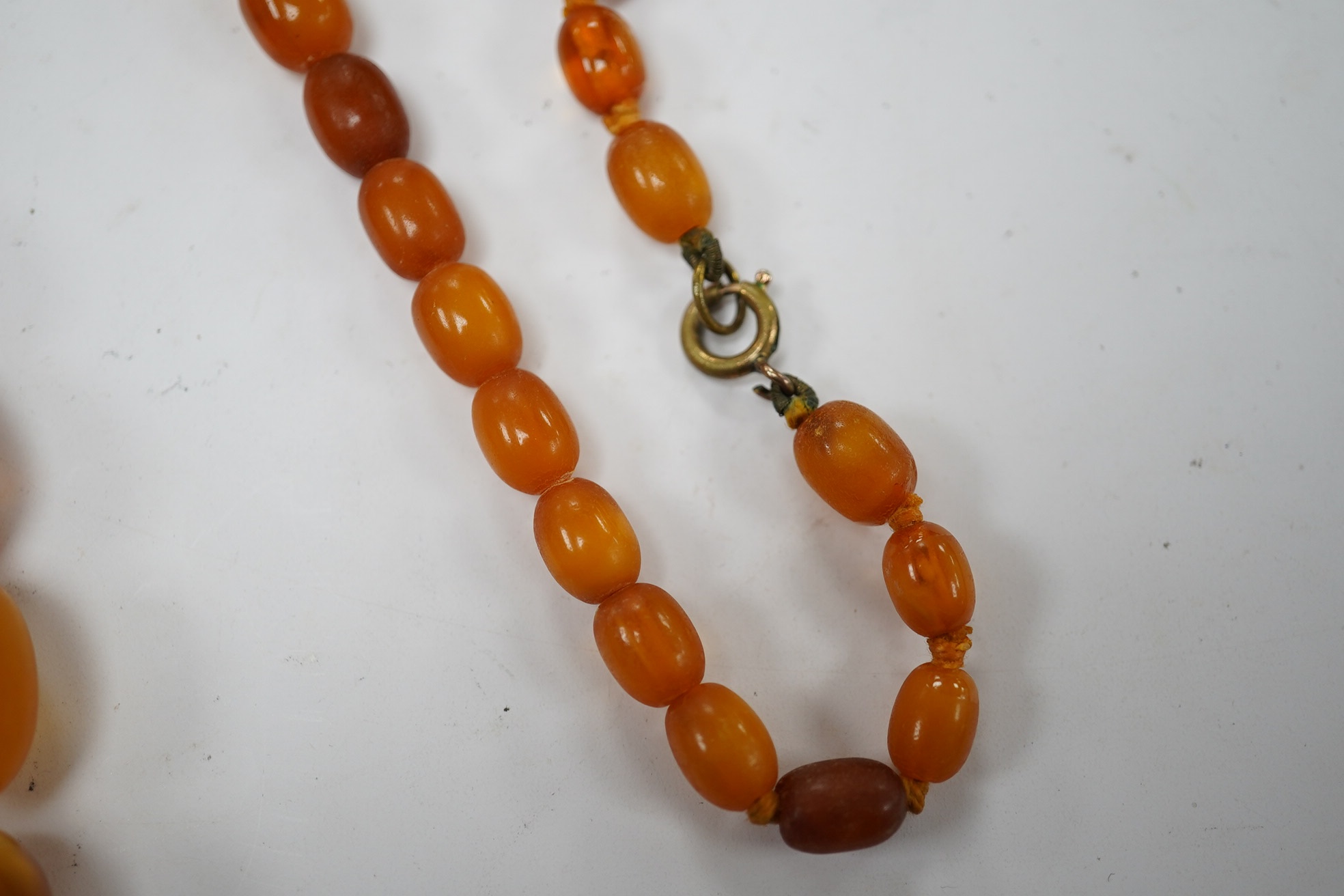 A single strand graduated oval amber bead necklace, 58cm, gross weight 34 grams. Condition - poor to fair